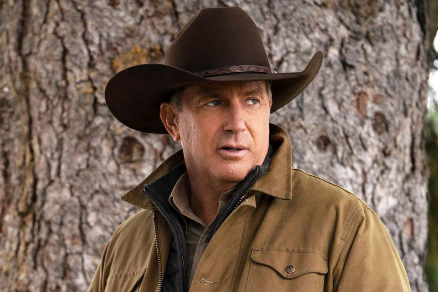 Kevin Costner overlooking his shoulder as John Dutton in a still from Yellowstone