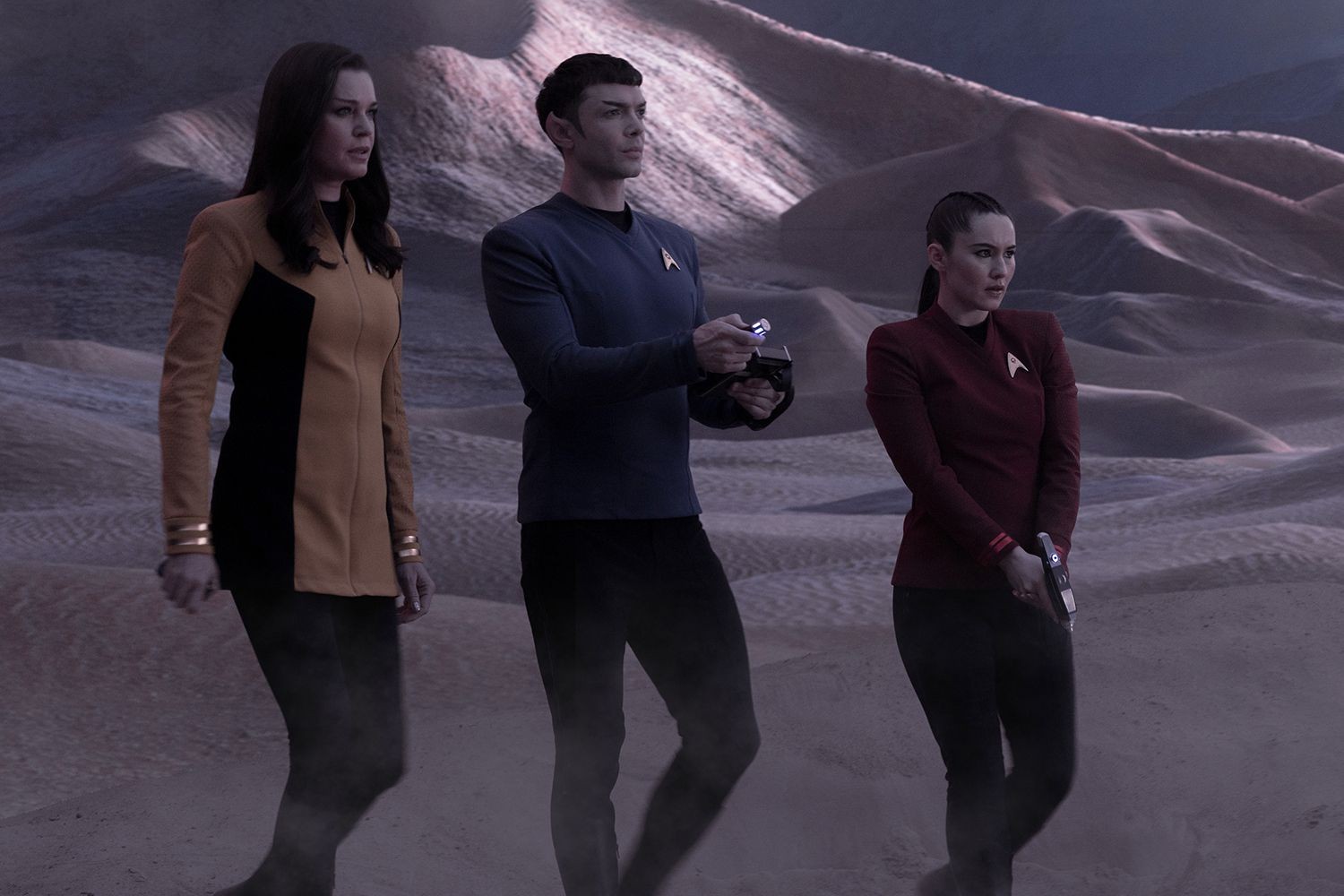 A still from Star Trek: Strange New Worlds featuring its cast walk in a new world