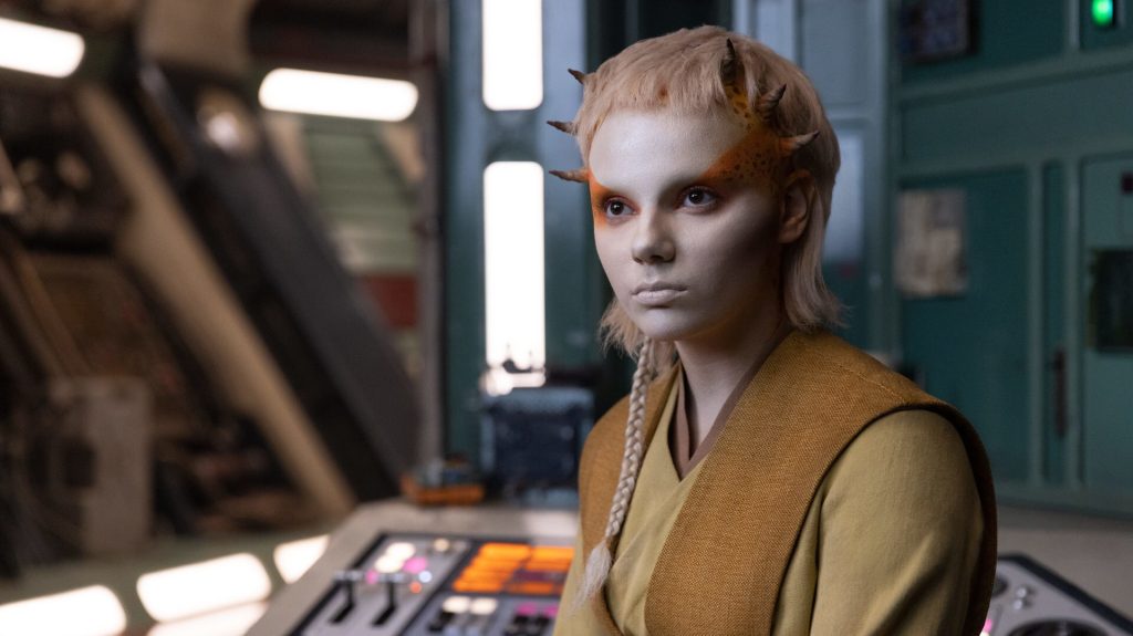 Dafne Keen sporting a grin as Jecki Lon, in her Jedi costume, in The Acolyte.