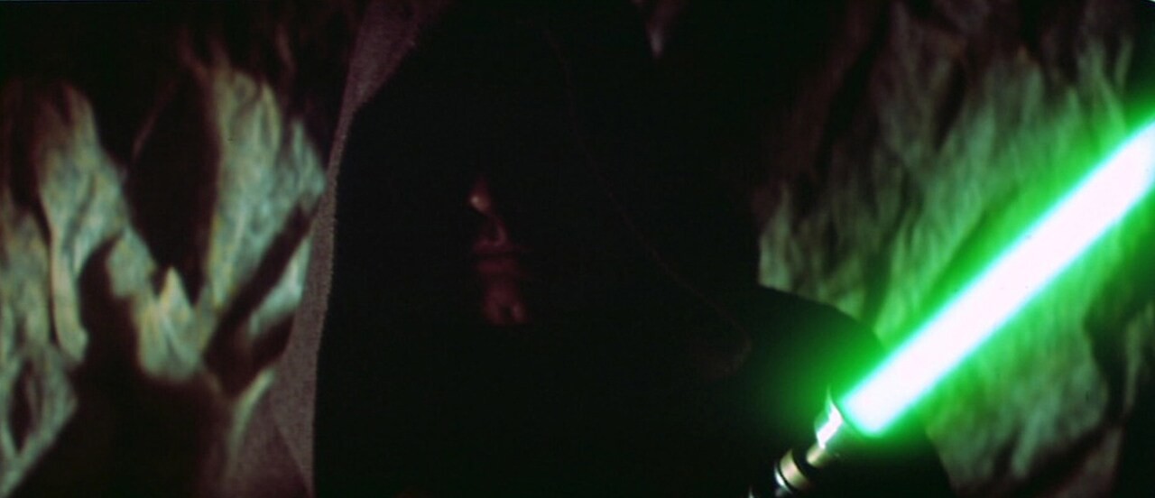 Luke Skywalker firing up his green light saber as Darth vader reaches out