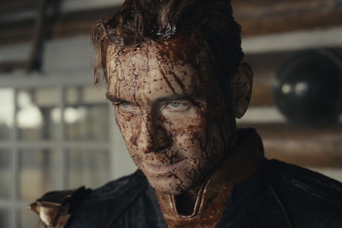A weary Homelander drenched in blood in a still from The Boys