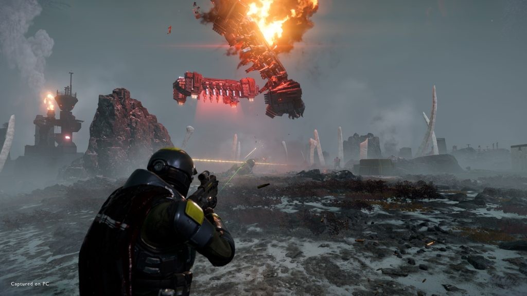 A battle taking place in Helldivers 2 with a ship exploding in the sky. 