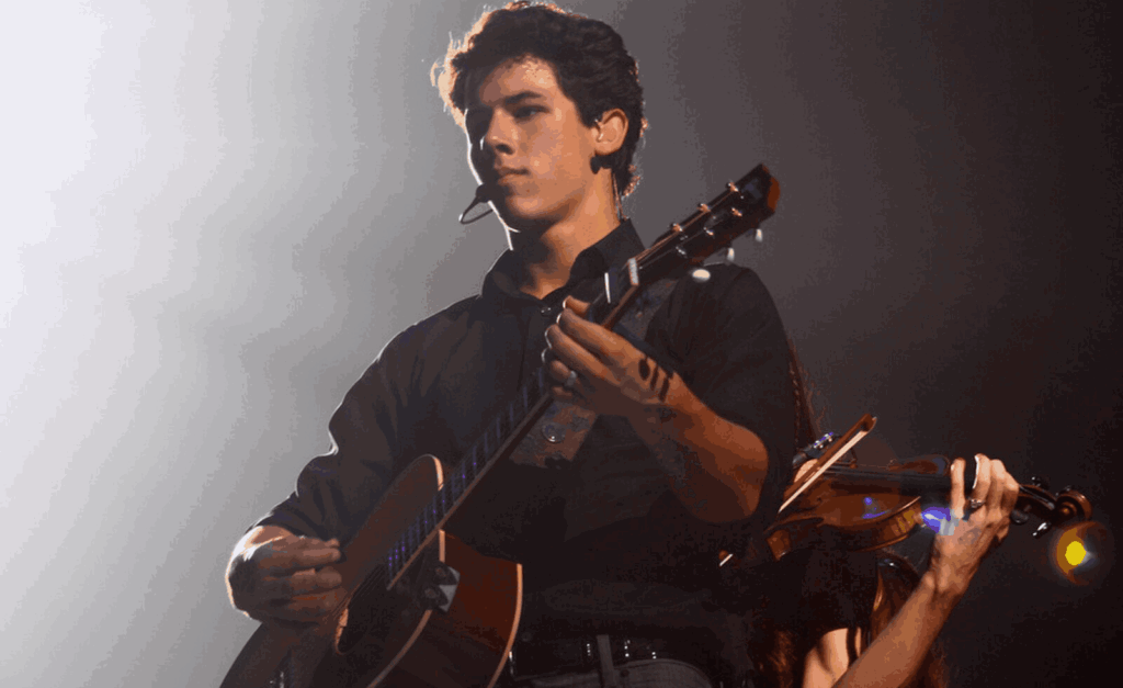 Who Is Nick Jonas Playing in Shout It Out Loud? Meet His Kiss Icon Role 8 Pop icon Nick Jonas | image: Samborowski, licensed under Creative Commons Attribution 2.0, via Wikimedia Commons