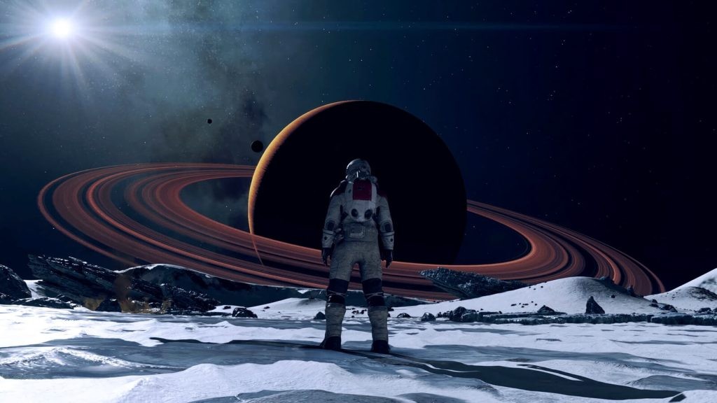 Starfield screenshot of a character in a spacesuit on the barren surface of a planet, gazing at another Saturn-like planet in the distance.