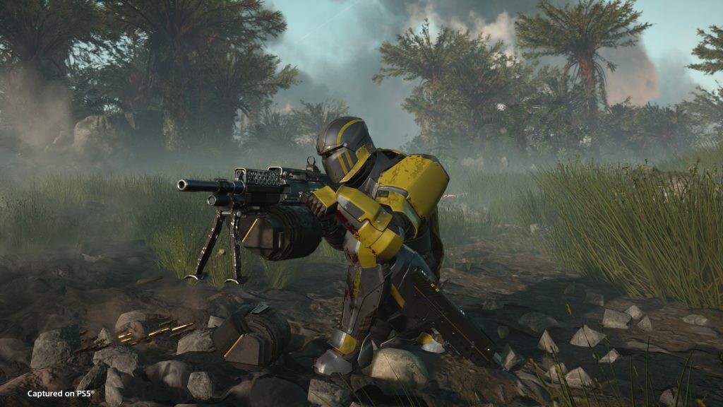 A still from Helldivers 2, featuring a Helldiver wielding the Heavy Machine Gun.