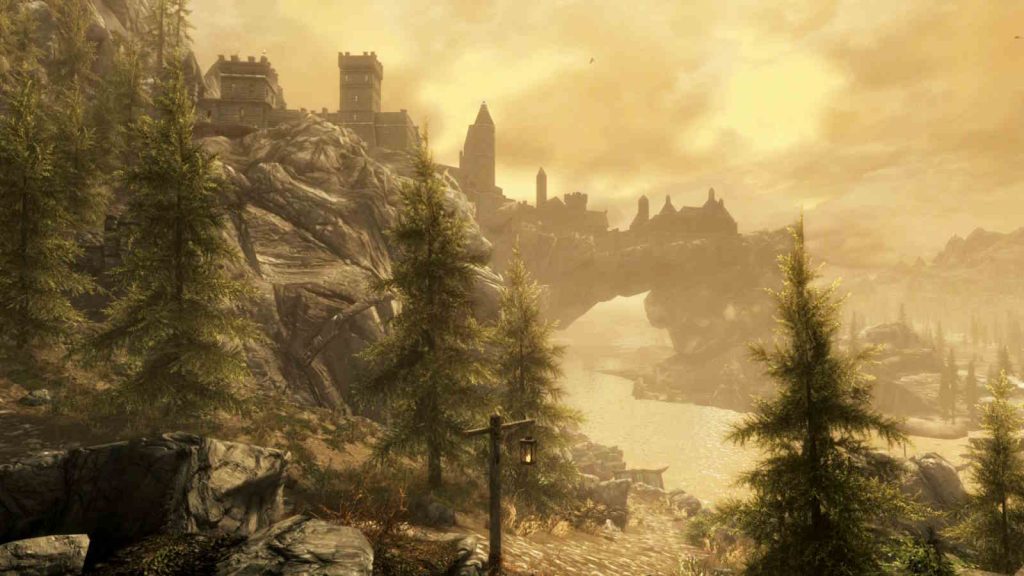 Screenshot of The Elder Scrolls V: Skyrim showing Tamriel's landscape with trees and a castle at dusk.