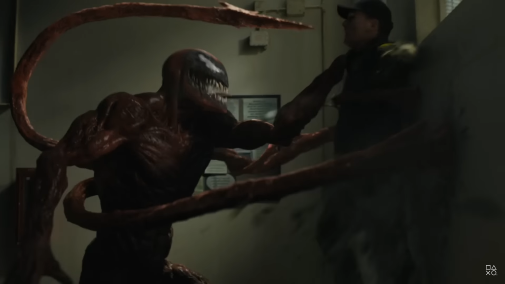 Carnage from the movie holding a guard up against a wall. 