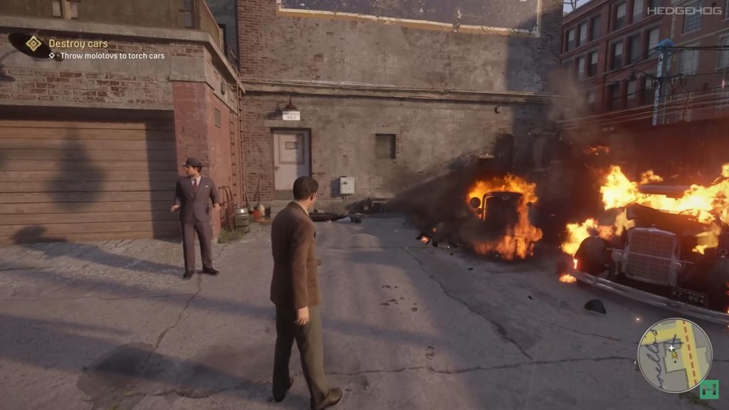 A screenshot from the game Mafia showing characters destroying cars with Molotovs.