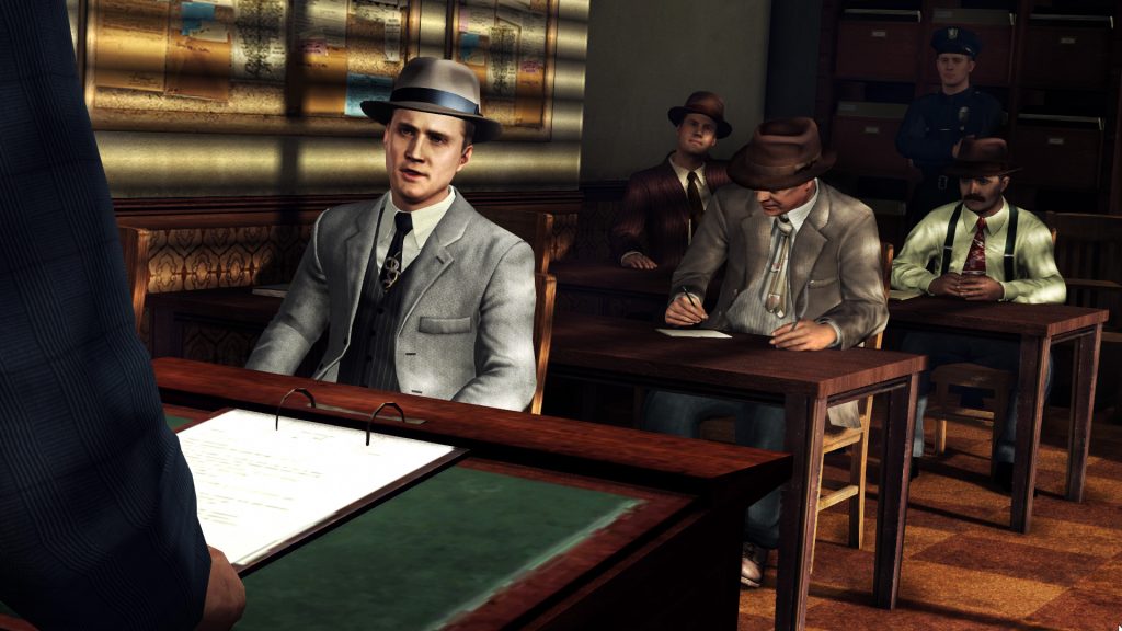 Cole Phelps from LA Noire sitting in a meeting with other investigators.