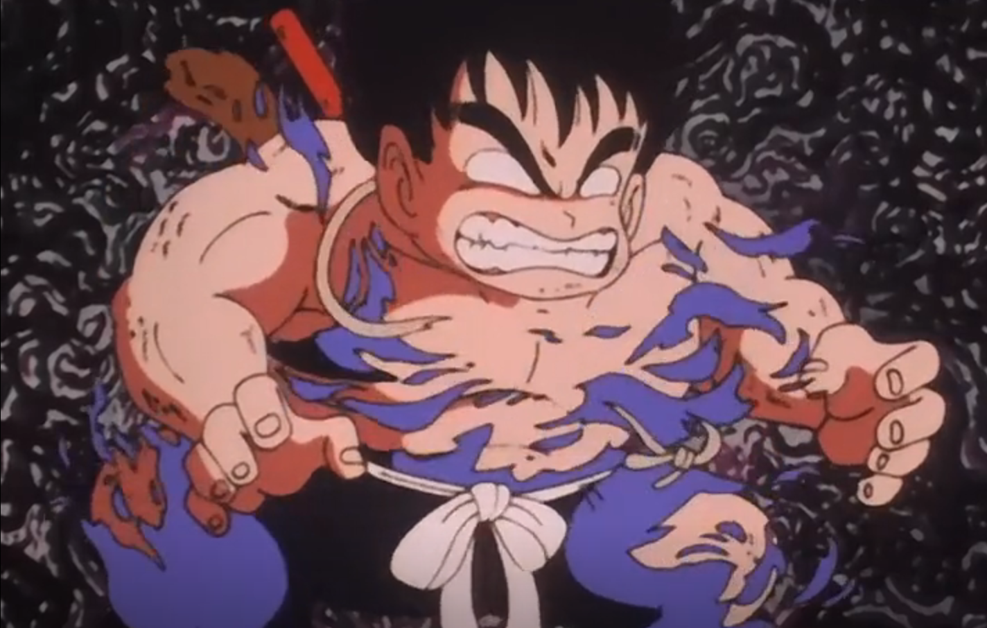 Goku is undergoing a transformation and looks angry 