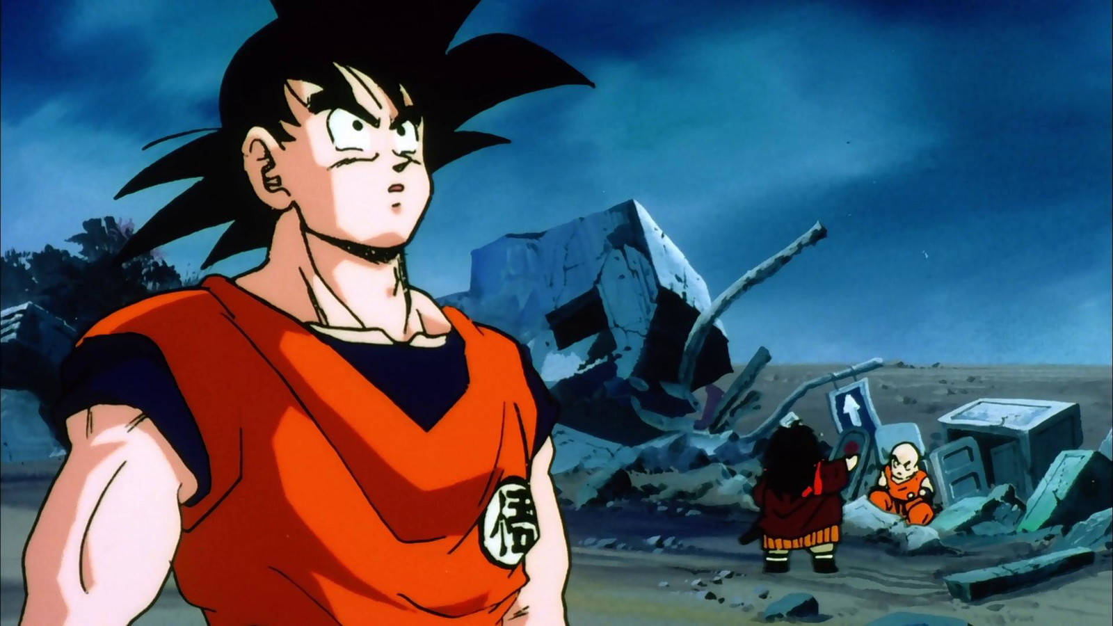 Goku is looking upwards with Krillin in the background 