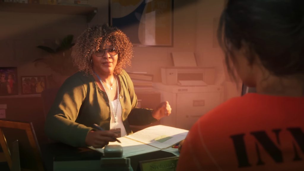 GTA 6 trailer screenshot featuring the game's protagonist, Lucia talking to a counselor in prison.