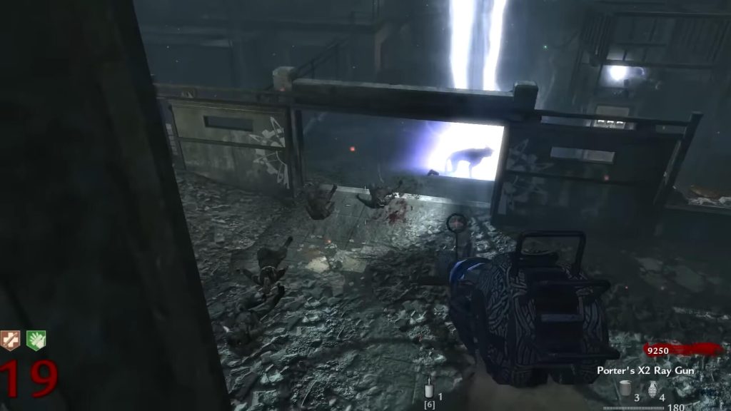 A user is standing with a ray gun in his hand as an enemy spawns in front of him.