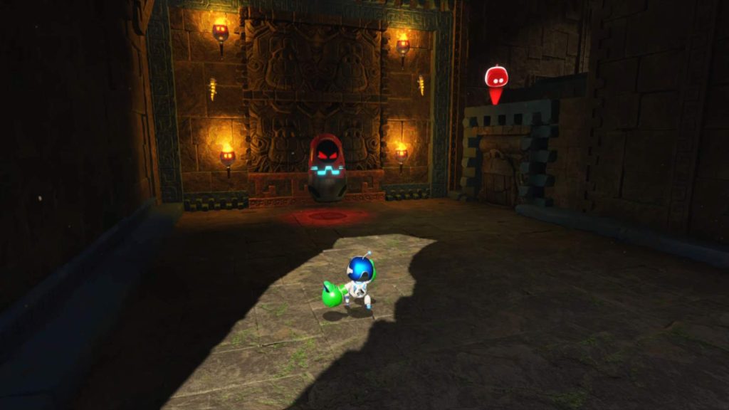 Astro Bot screenshot showing Astro in a cave facing a Russian-doll-shaped enemie