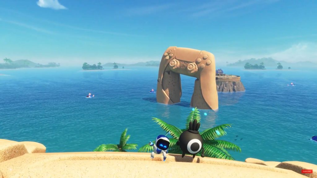 The character is sitting besides the fourth bot with a large PS5 controller made of sand in sight.