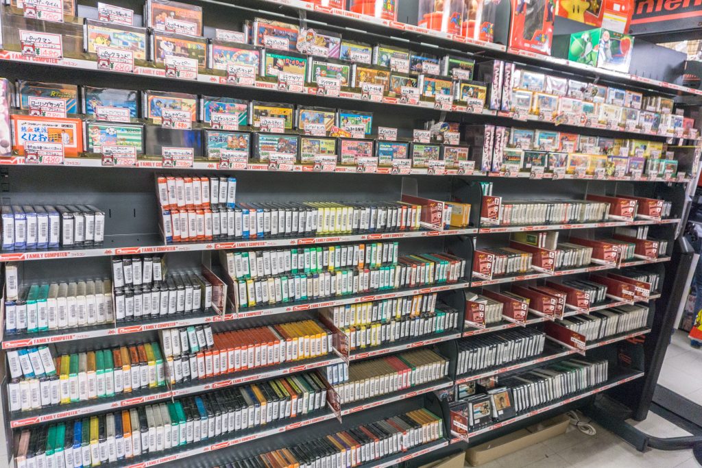 A large store shelf filled with various games.