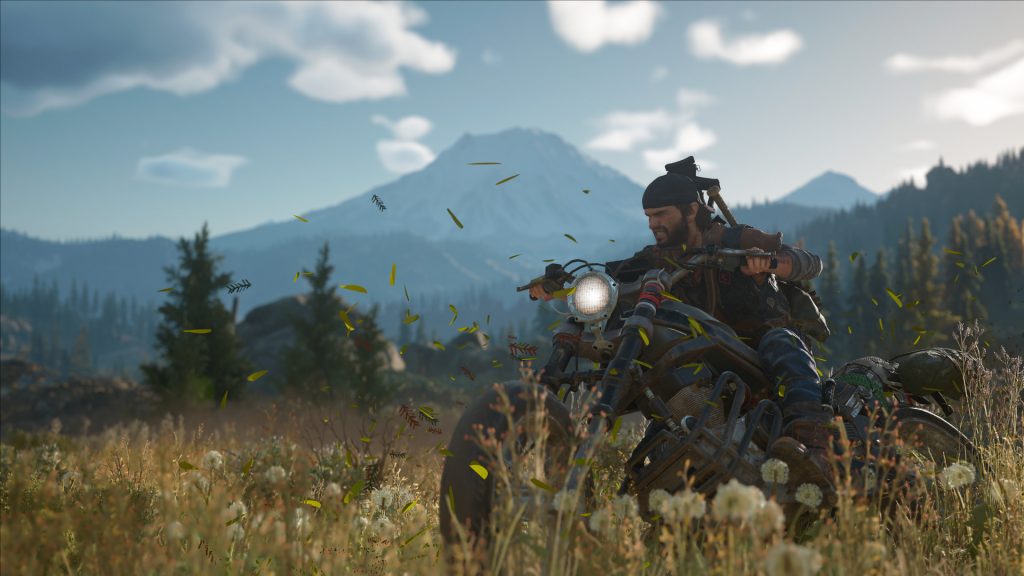 A still from Days Gone, featuring Deacon riding his motorcycle.