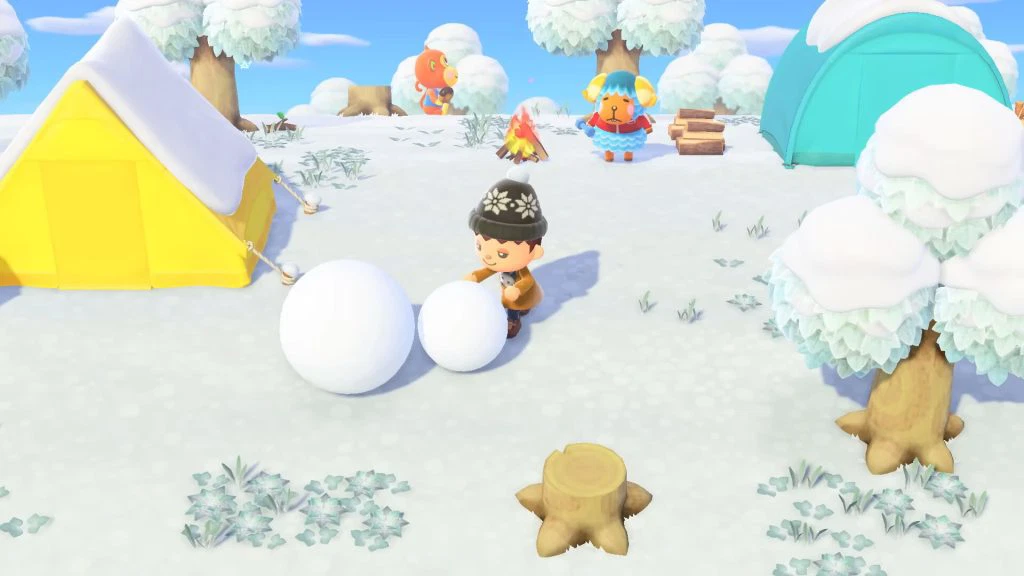 Animal Crossing gameplay screenshot shows player rolling a big snowball on their island in winter.