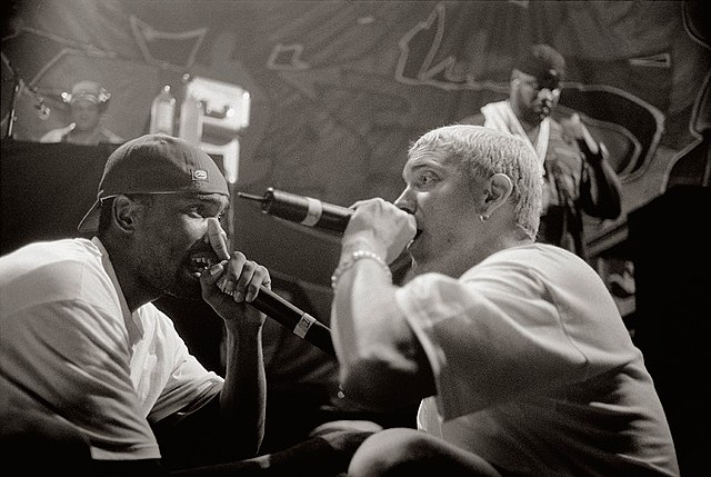 Proof and Eminem performing at the 1999 Juice Jam in Stadthalle, Munich [Photo by Mika Väisänen, licensed under CC BY-SA 4.0 via Wikimedia Commons]