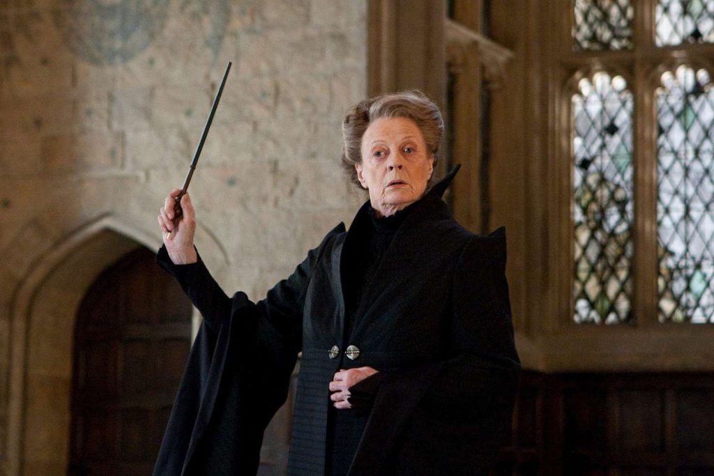 The late Maggie Smith raising her wand in a scene from Harry Potter