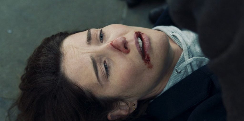 Cobie Smulders as Maria Hill laying on the ground and dying.