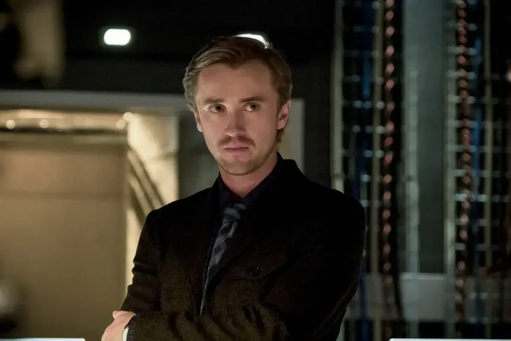 Tom Felton Returning as Draco Malfoy for New Harry Potter Project 1 Tom Felton looking off screen in The Flash.