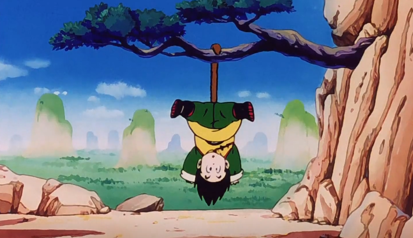 Gohan is hanging upside down from a tree in Dragon Ball Z Kai