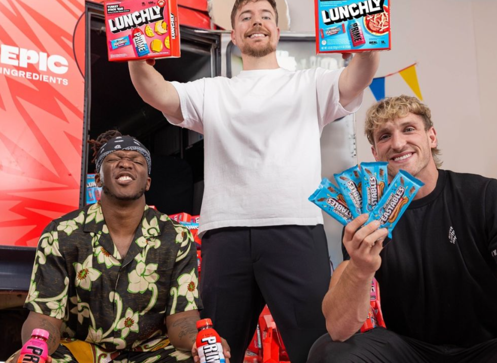 KSI, MrBeast, and Logan Paul pose with their product, Lunchly