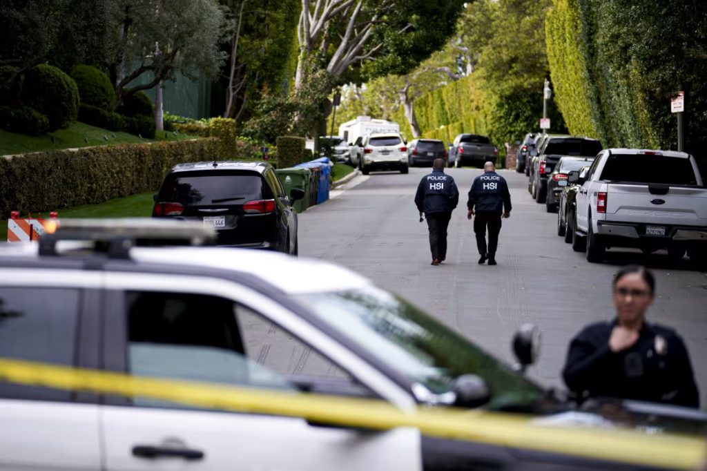 Police gather near Diddy's Los Angeles property on March 25.