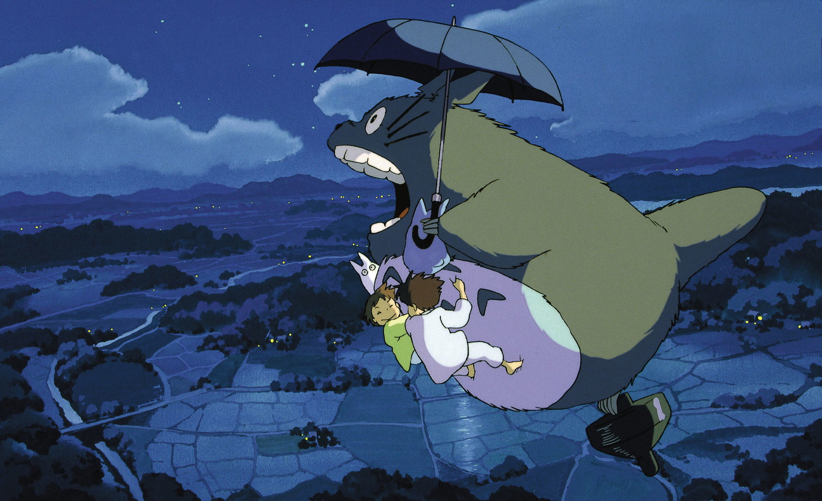 Totoro is flying with an umbrella in his hand in My Neighbor Totoro movie