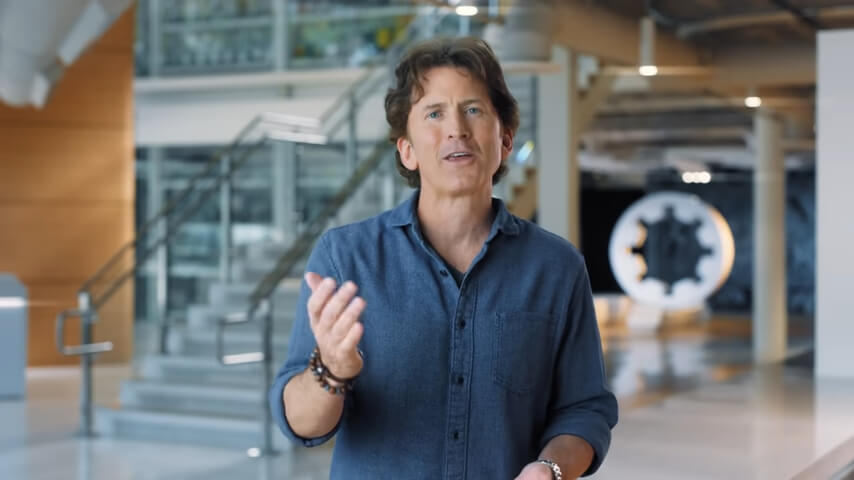 Todd Howard in close-up, with the interiors of Bethesda Game Studios HQ as the backdrop.