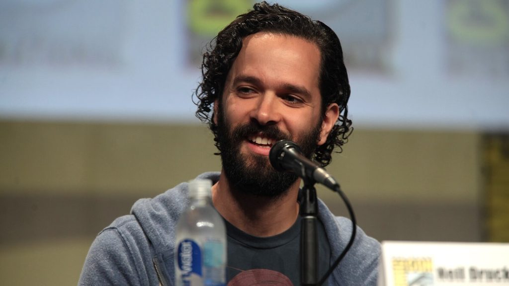 Neil Druckmann speaking at a convention.