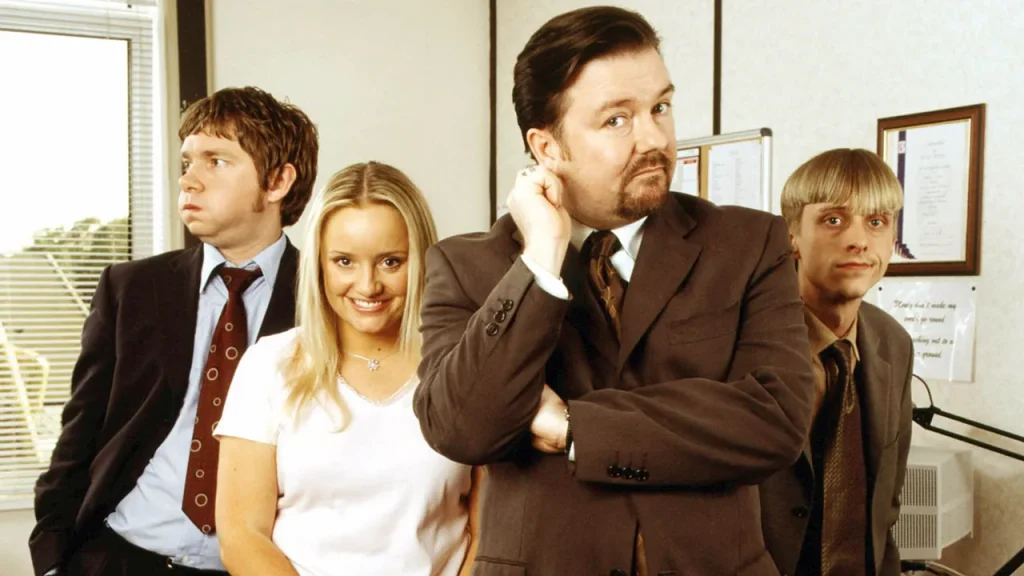 Ricky Gervais and other cast members in The Office UK | Credits: BBC