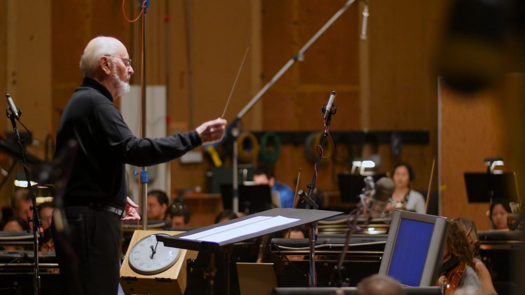 John Williams composes in a recording session. Footage is from Music By John Williams. 