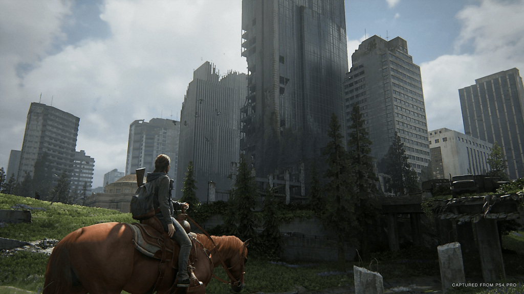 the image shows Ellie riding a horse to a city in The last of Us part 2