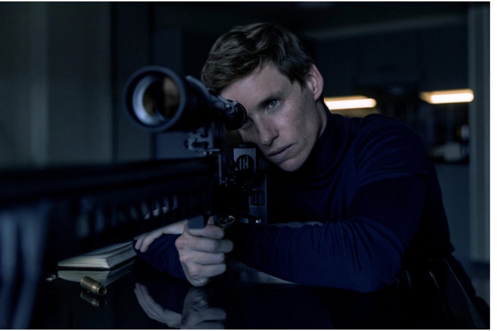 A scene from Day of the Jackal featuring Eddie Redmayne as the main character holding a sniper rifle