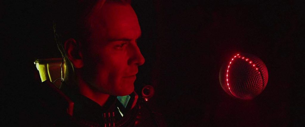 Ridley Scott directs Prometheus - Michael Fassbender is covered in red light. 