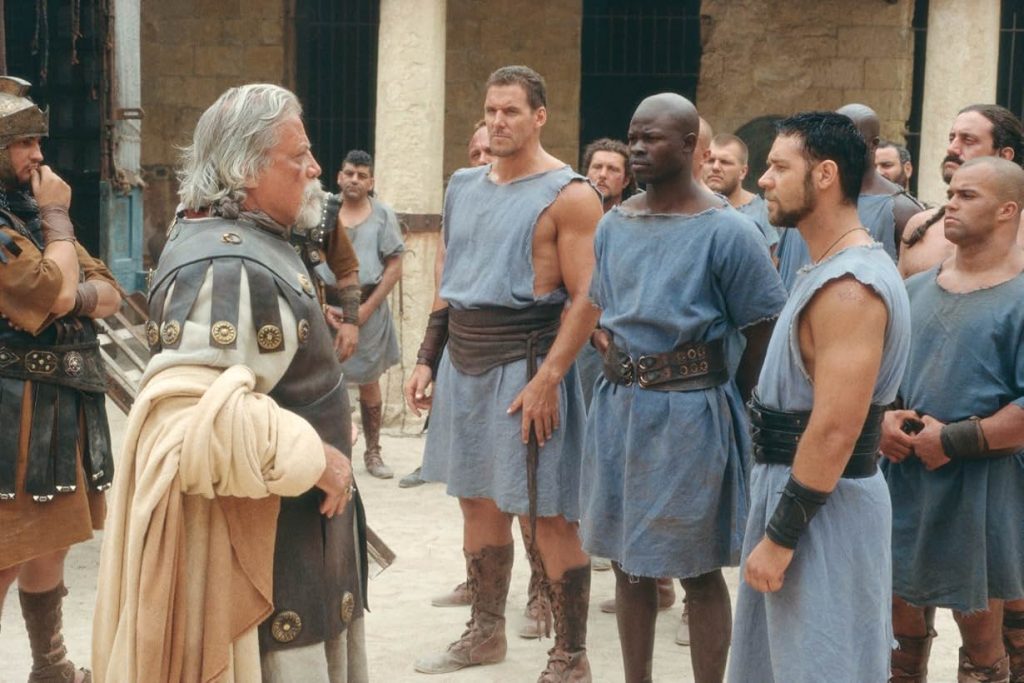 Russell Crowe, Oliver Reed, Djimon Hounsou, Ralf Moeller, among others in a still from Gladiator (2000)