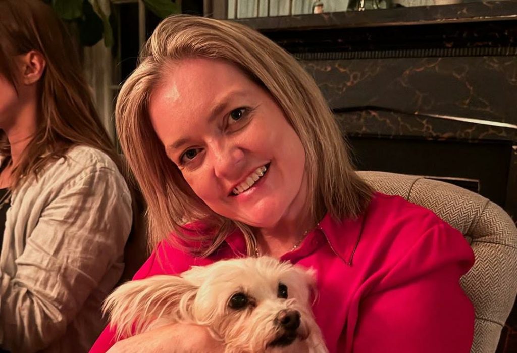 Colleen Hoover holding a Pomeranian dog in a picture posted by her on her Instagram