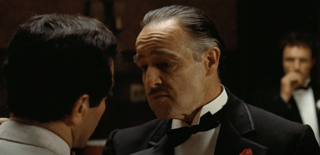 Marlon Brando as Don Vito, confronting a man in The Godfather. 