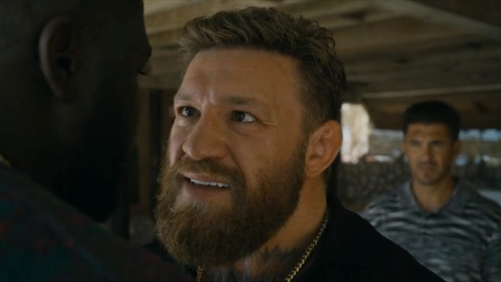 Conor McGregor in a scene from the movie Road House, portraying a rugged character.