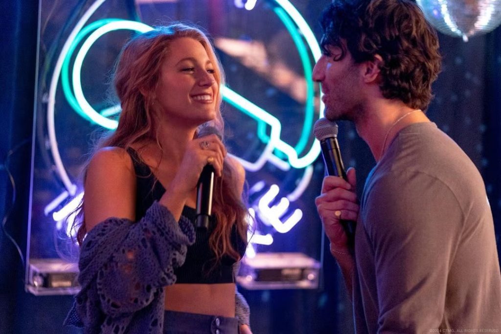 Blake Lively and Justin Baldoni singing in a scene from It Ends With Us