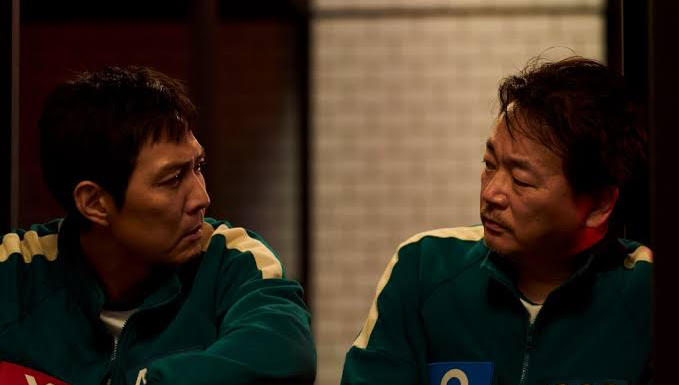 Lee Jung-jae as Seong Gi-hun with his onscreen best friend Jung-bae (Lee Seo-hwan) in Squid Game S2