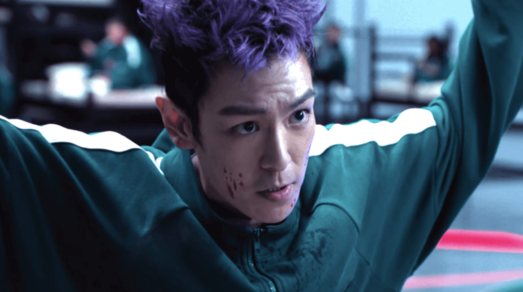 Choi Seung Hyun with purple hair, as Thanos in Squid Game. 