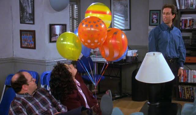 A still from Kramer’s Millennium New Year’s party arrangement, featuring Jerry, George, and Elaine.