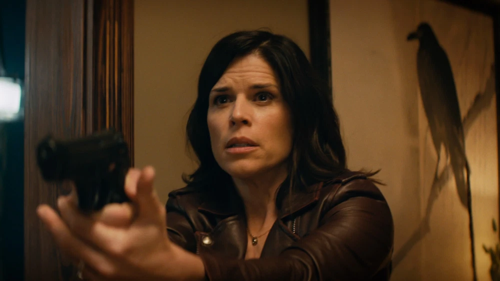 Neve Campbell as Sidney Prescott, holding a handgun, in Scream 