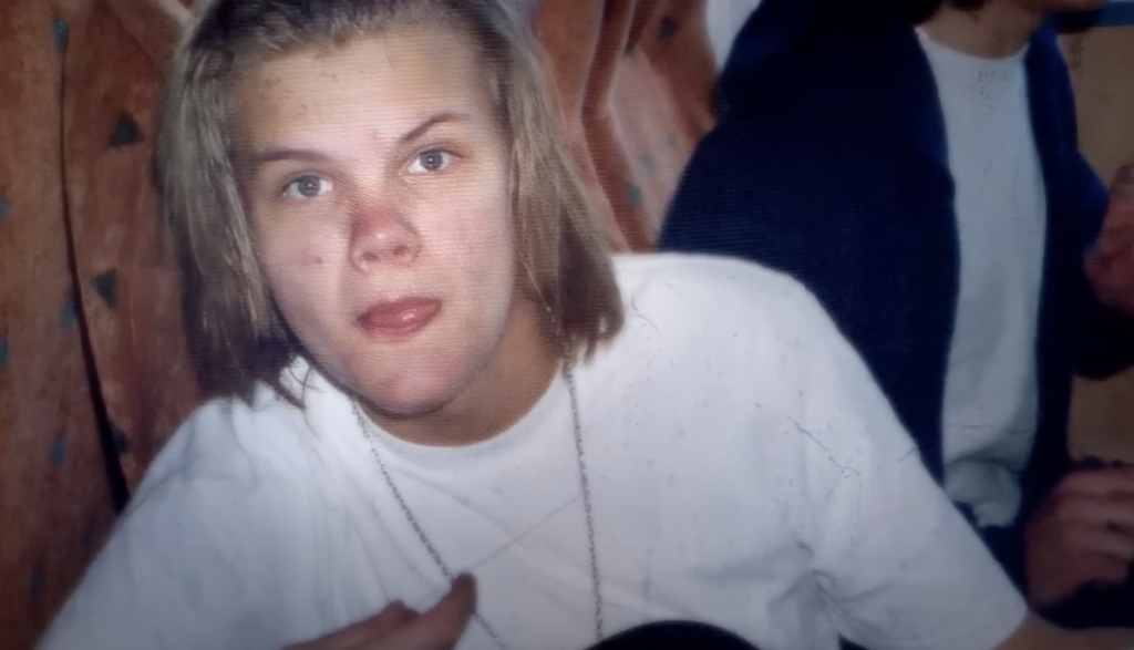 Young Avicii with long blonde hair and a white T-shirt. 