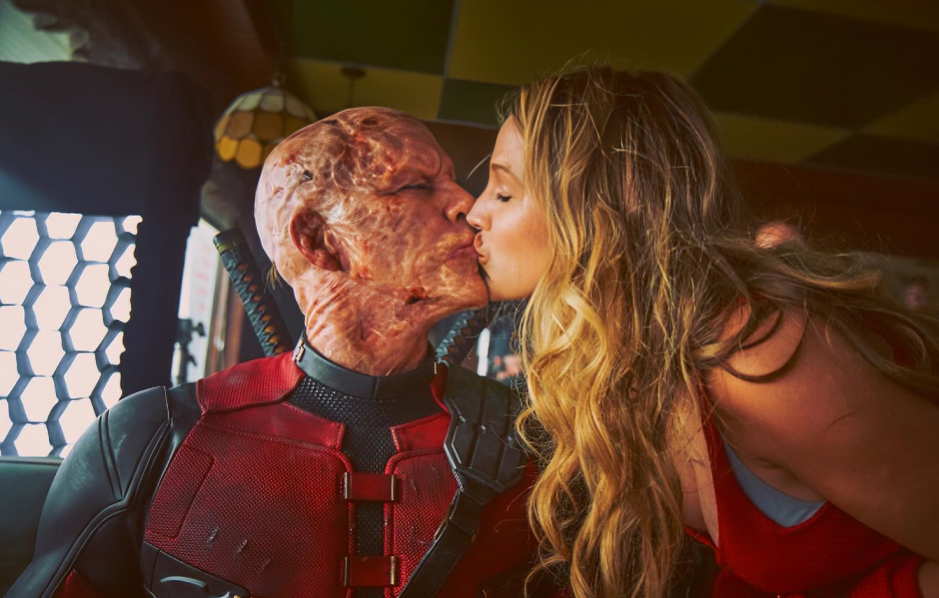 Ryan Reynolds as Deadpool kissing Blake Lively on the sets of Deadpool and Wolverine.