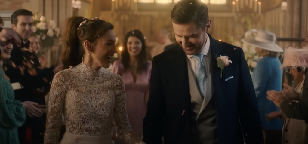 Michelle Keegan and Richard Armitage walking down the aisle after a wedding ceremony 