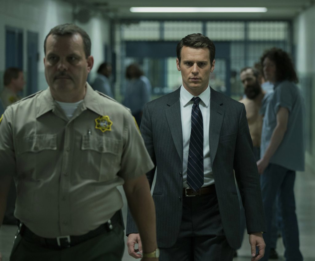 Jonathan Groff's Holden Ford walking with Tom Carlson's character in Mindhunter